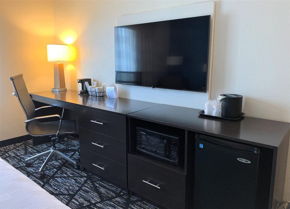Desk, laptop workspace, iron/ironing board, travel crib