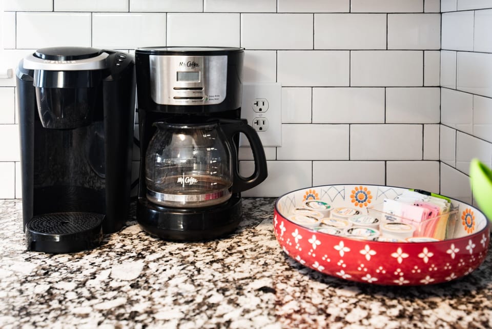Drip Coffee Maker & Single serve cups of coffee provided.