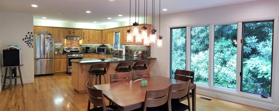 Table expands to 8. Padded, comfy chairs & stools. Creek is under the window.