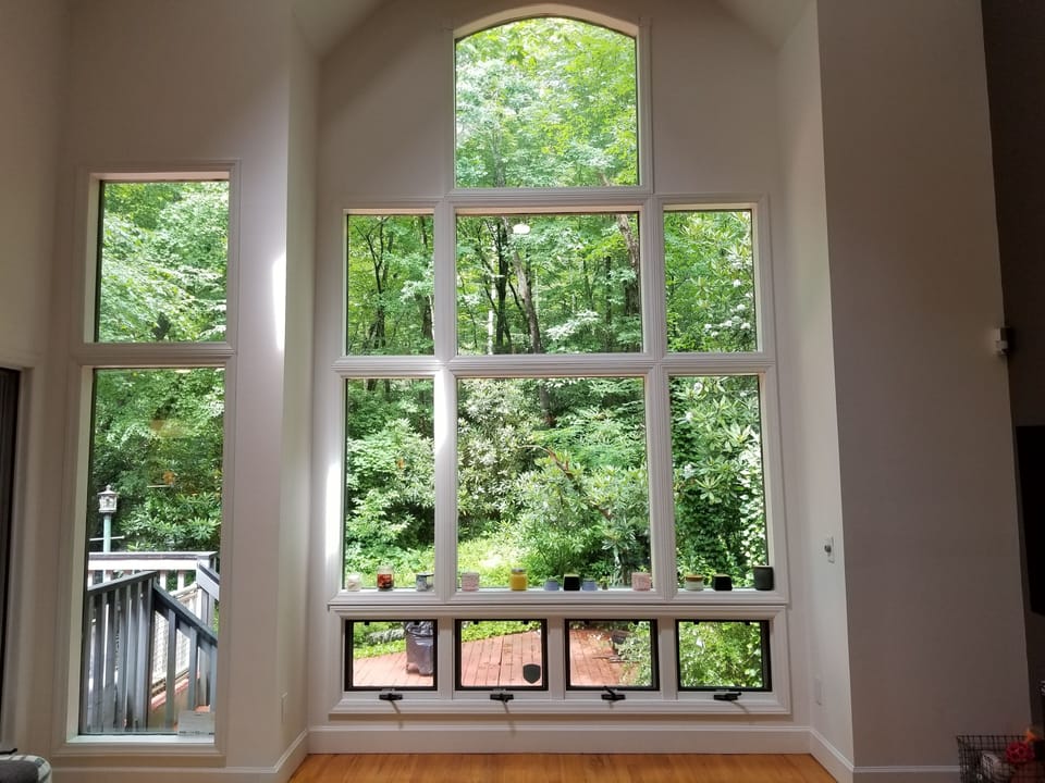 Living room with nothing but greenery. The creek is just at the edge of deck.