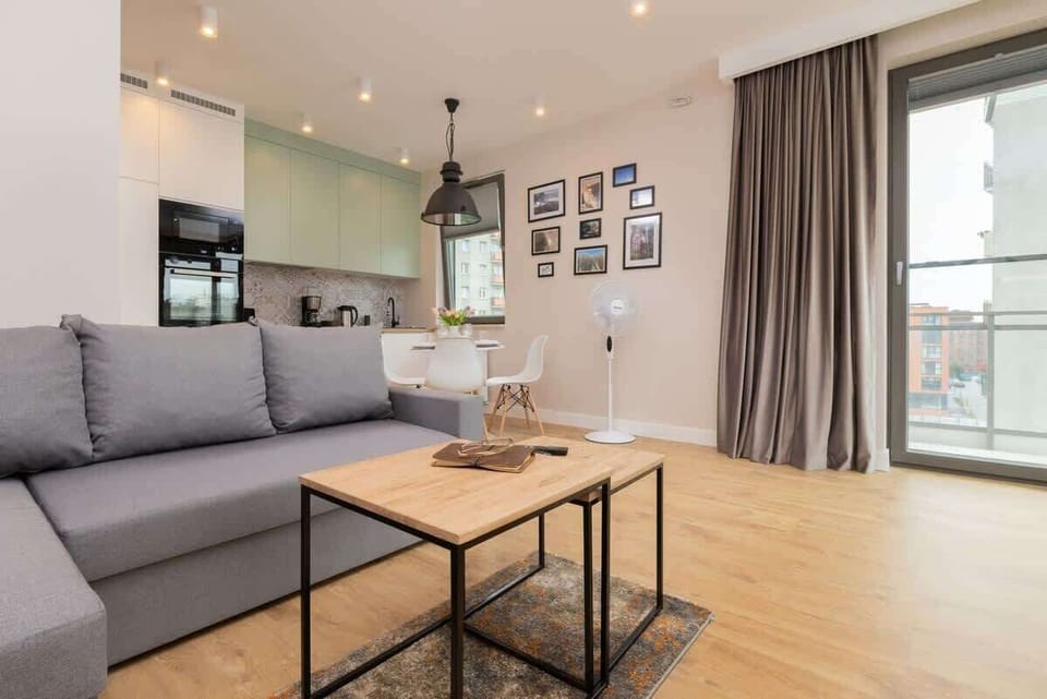 Relax in the stylish living room with a comfortable sofa and modern decor.