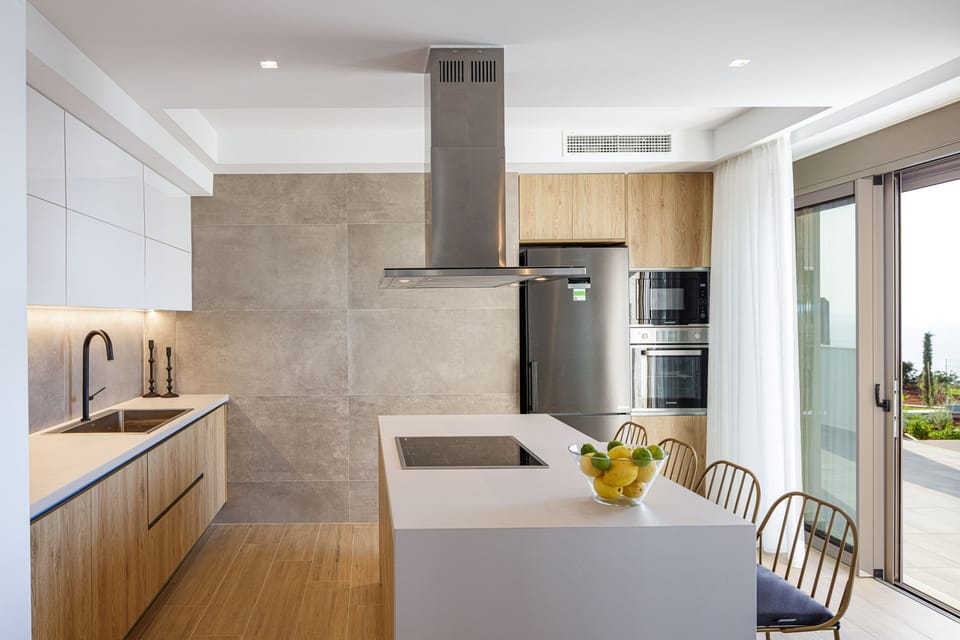 Sleek kitchen with top-brand appliances and island seating.