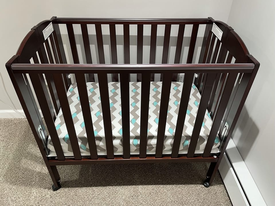 Portable mini crib with an infant safe mattress, 
