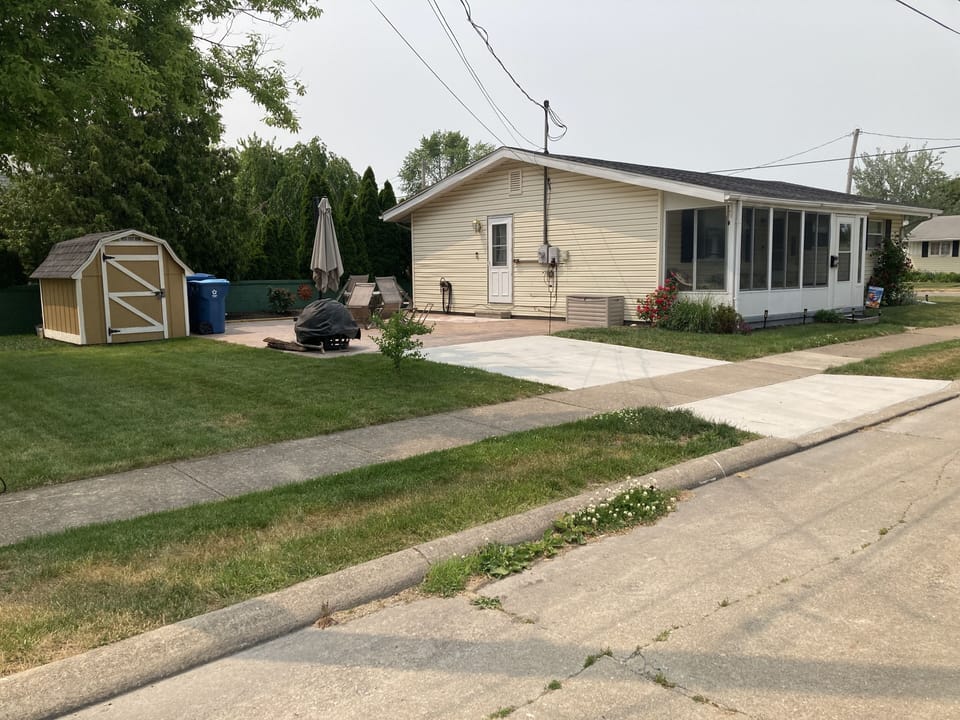 House, shed, patio with fire pit,
table and chairs for 6,  and shade umbrella. 