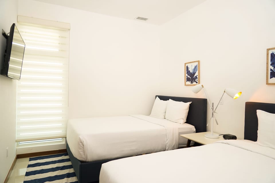 Relax in your cozy twin bedroom featuring crisp linens, modern décor, and ambient lighting. A peaceful retreat where you can unwind after a day of adventure.