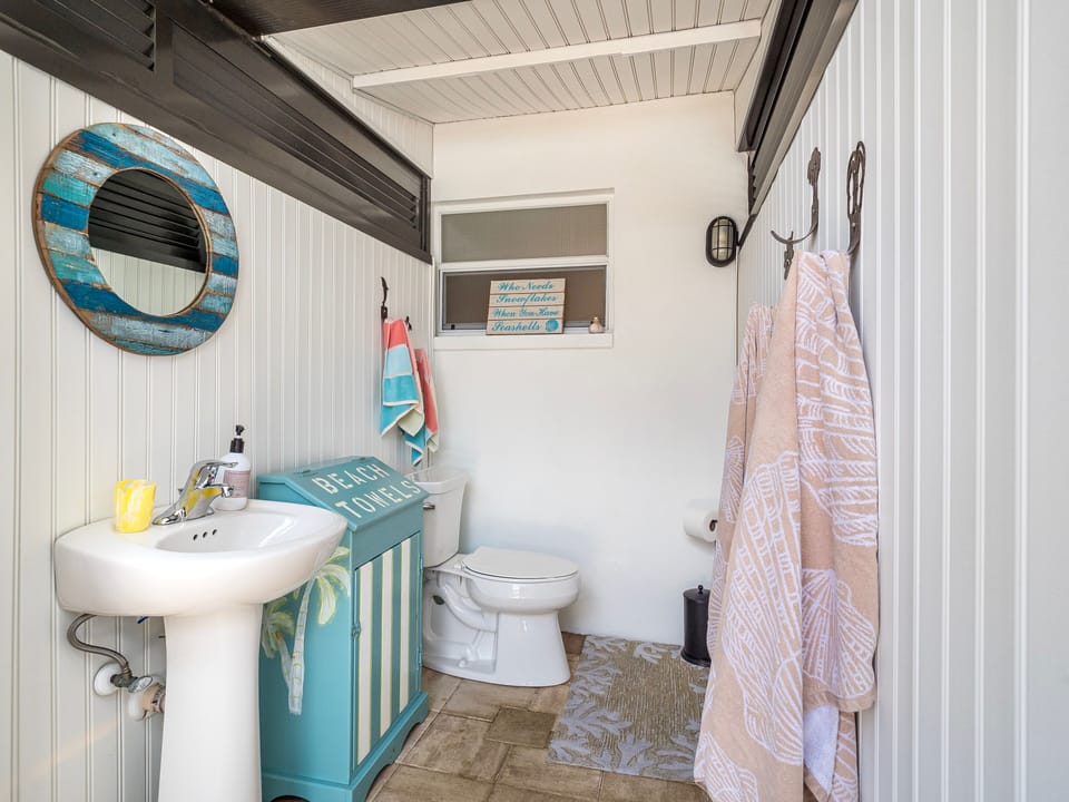 This is an outdoor bathroom off the pool patio, not inside the house.