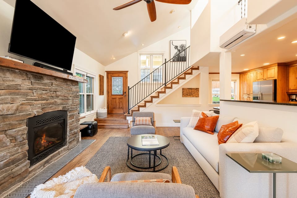 Living Room with 48" Smart TV, gas fireplace, plush furnishings, and Private BBQ patio access