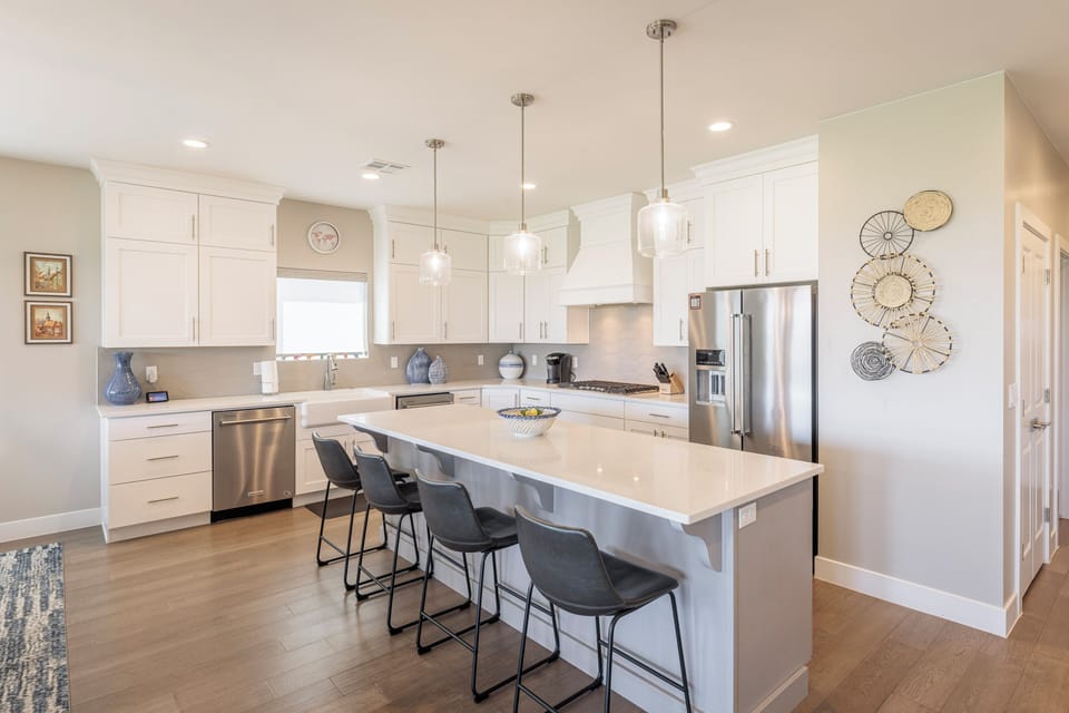 Kitchen View - The kitchen is complete with everything you will need for meal preparations.  The gourmet kitchen includes a large farmhouse sink, 5-burner gas cooktop, and 2 full size dishwashers, ovens, & refrigerators.