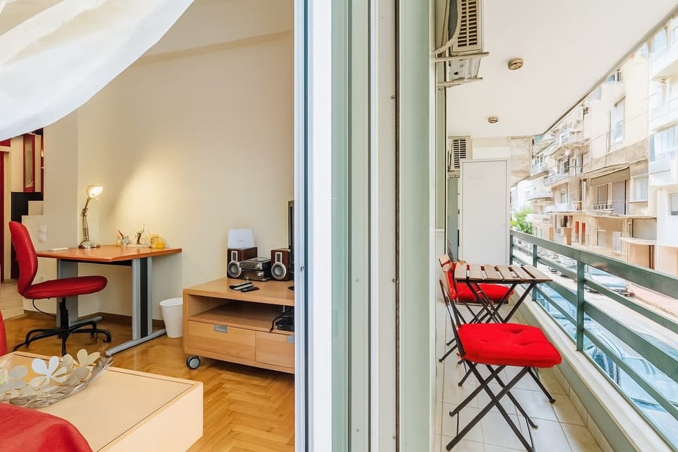 Balcony – Enjoy the Urban Vibe of Athens
Overlooking a quiet city street, the balcony includes a bistro table set perfect for breakfast or evening wine.