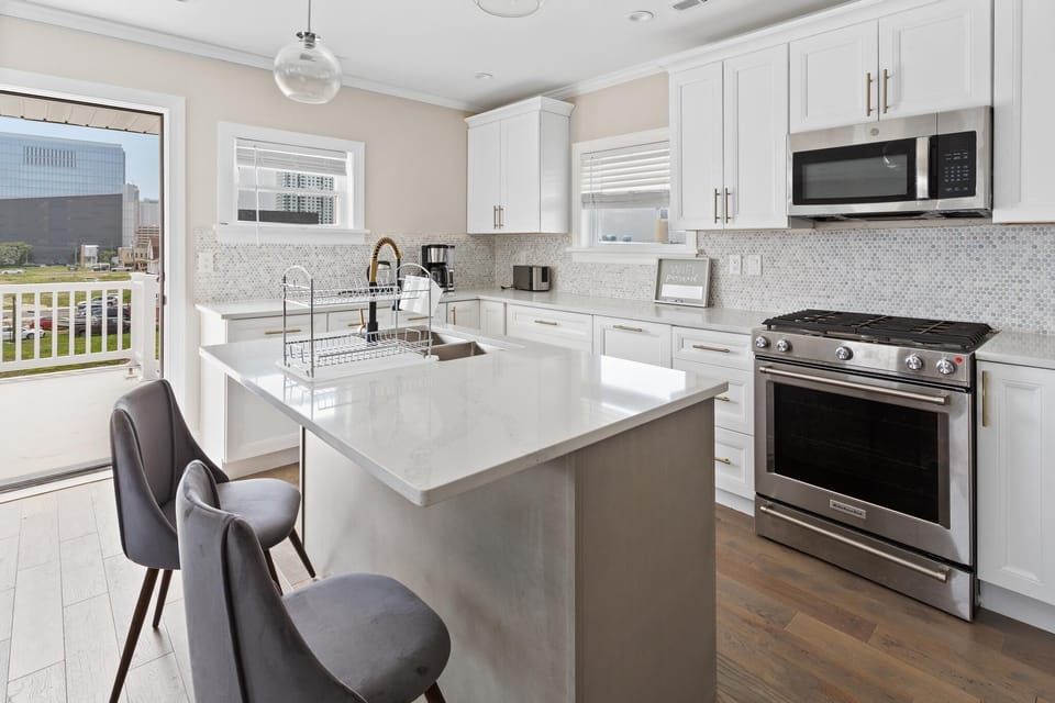 Enjoy the main floor where you will find the large gourmet kitchen complete with custom cabinetry, sleek calacatta quartz countertops, high-end appliances and an island breakfast bar