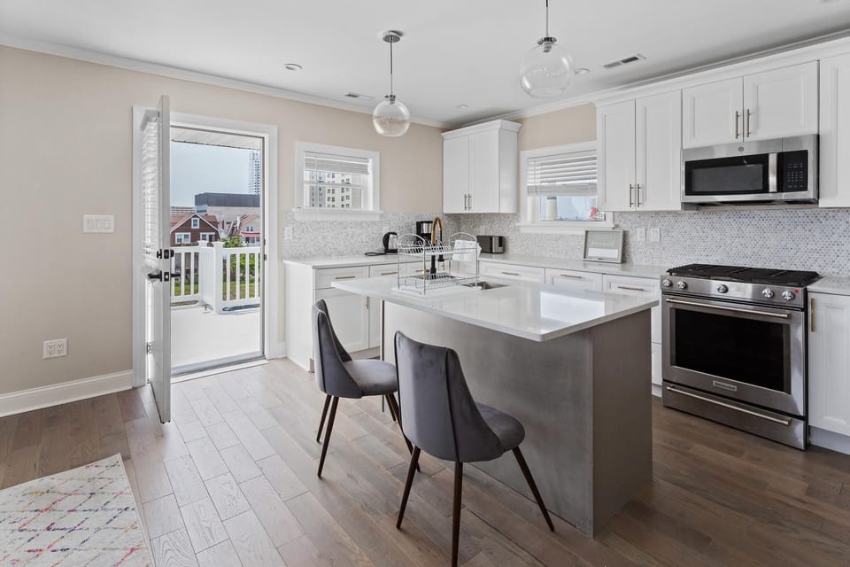 Enjoy the main floor where you will find the large gourmet kitchen complete with custom cabinetry, sleek calacatta quartz countertops, high-end appliances and an island breakfast bar