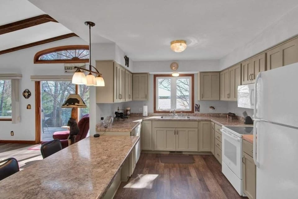 Kitchen with a dishwasher, fridge, and a view 