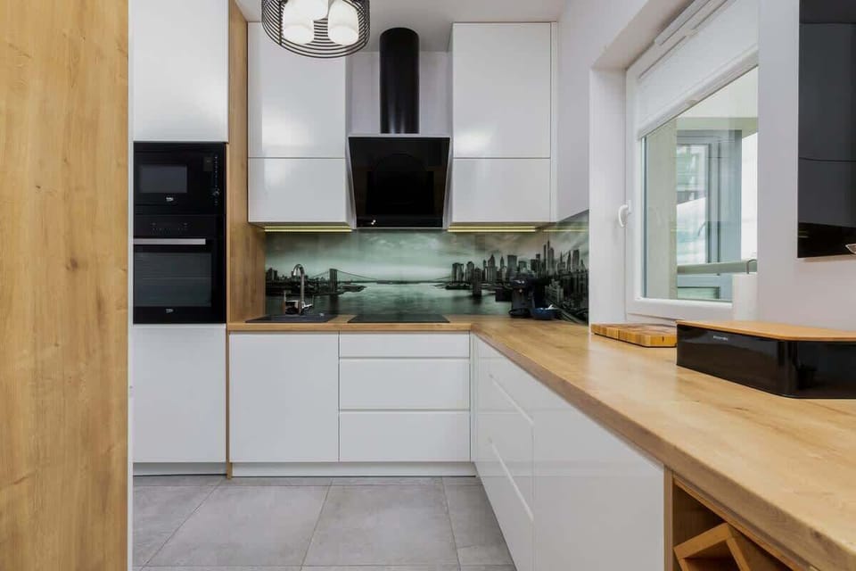 A modern kitchen with an open design, wooden accents, and a functional island separating it from the dining area.