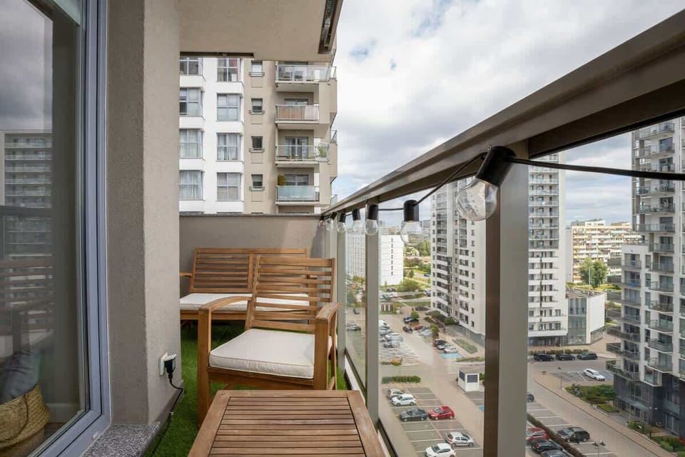 A detailed view from the balcony showcasing high-rise buildings and a vibrant urban environment.