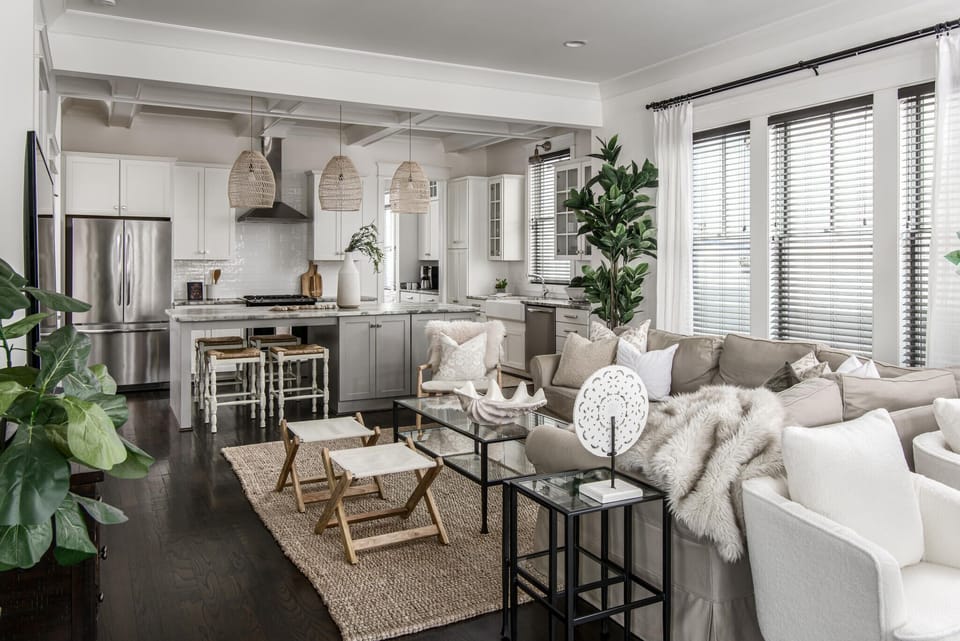 The larger main living space connects to the kitchen with an eat in island.