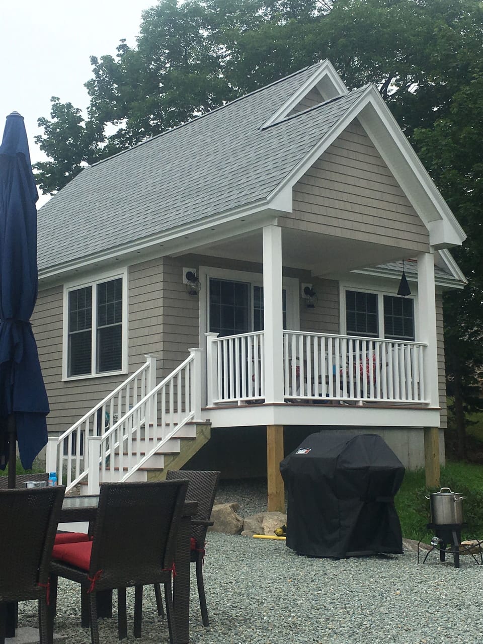 Shared patio with grill, lobster cooker and table.