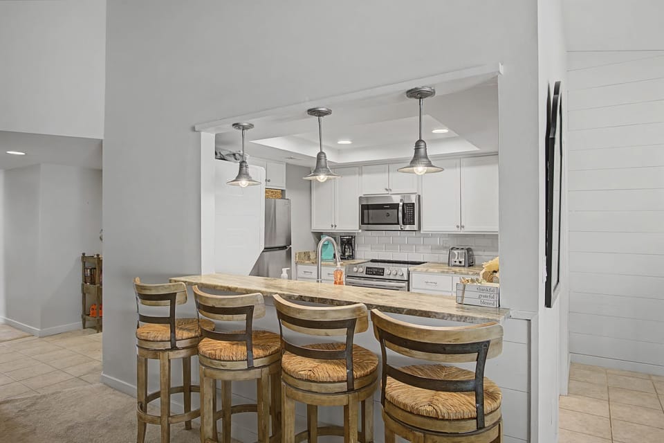 Your fully equipped kitchen features a breakfast bar where you can enjoy morning coffee while planning your day's adventures.