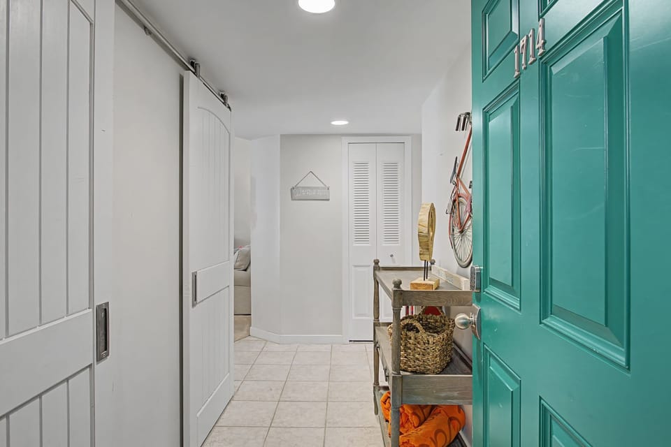 Your private laundry room features barn doors and turquoise cabinets, creating a cheerful space for all your washing needs.