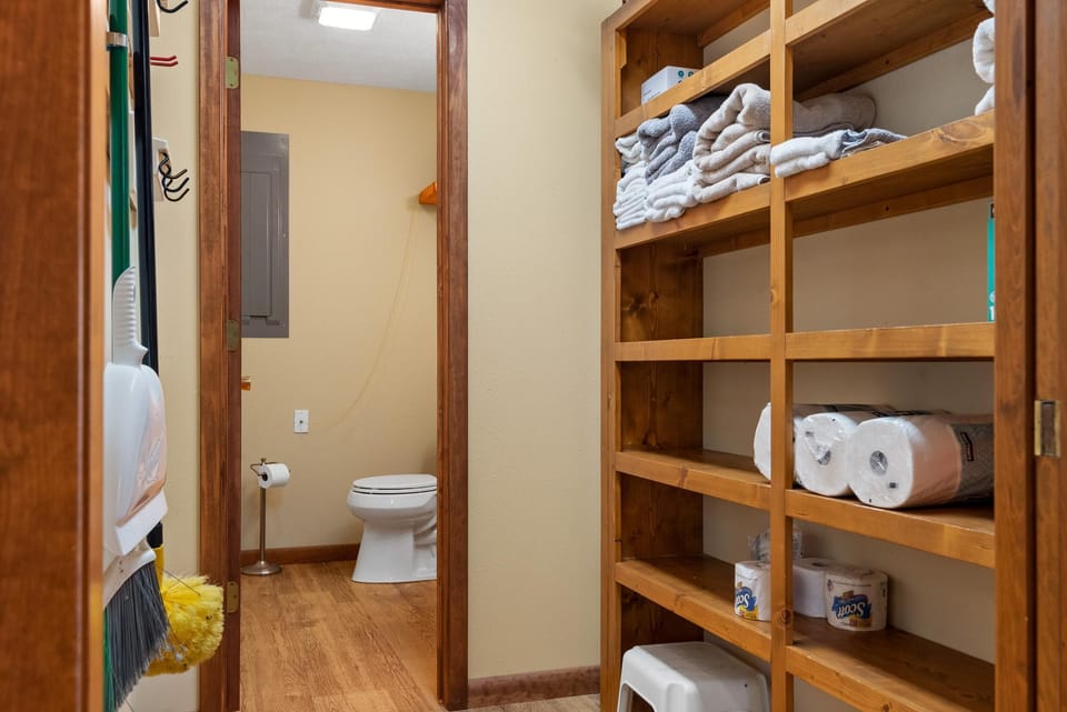 Half bathroom and storage pantry off kitchen