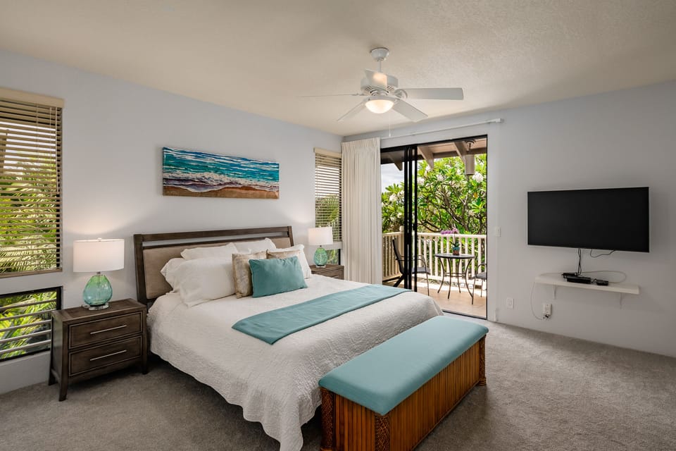 Master bedroom with balcony access and flatscreen TV