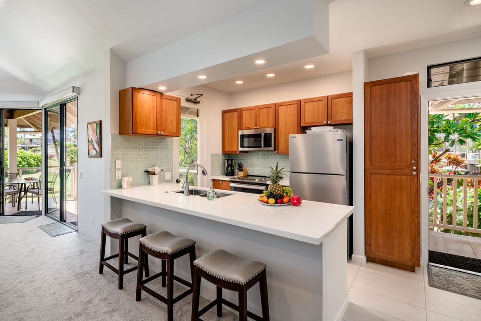 Bright kitchen with breakfast bar and stainless steel appliances