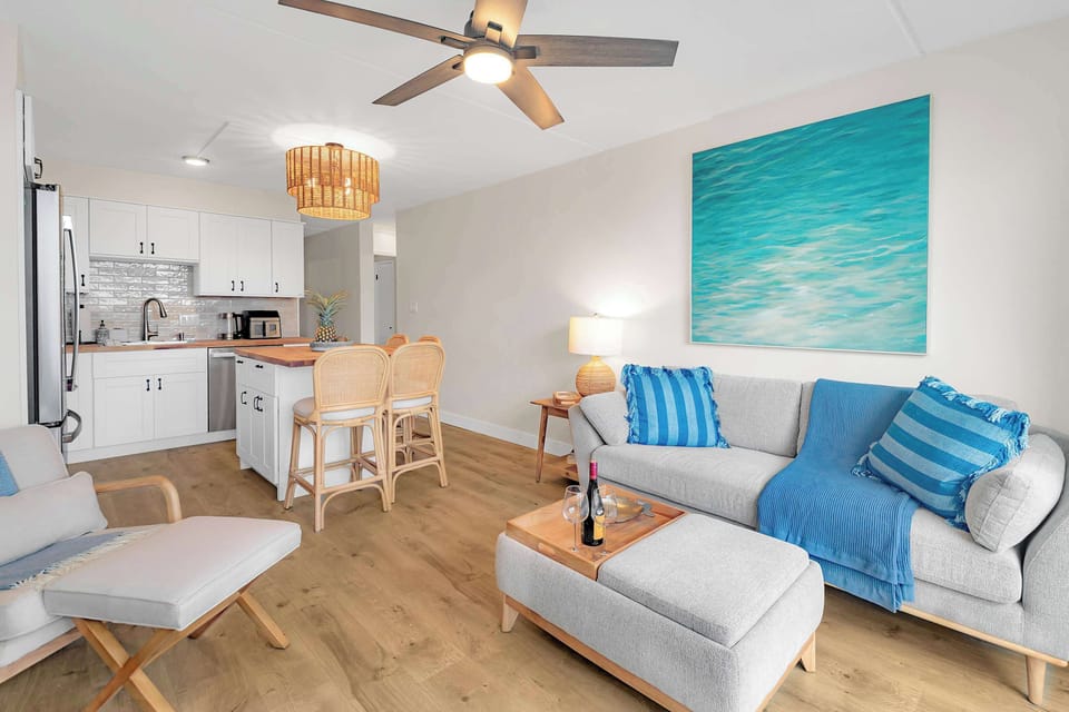 Puako Beach Condo #102 - Living Room and Kitchen with stainless steal appliances and island.