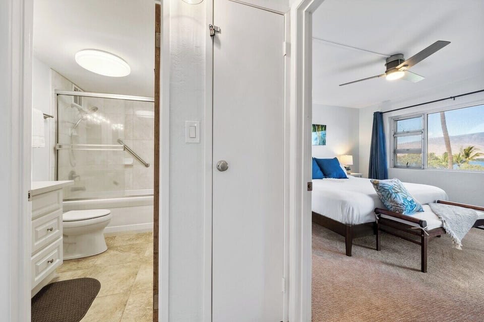 A fresh bathroom features a walk‑in shower and bright finishes for a clean, modern feel.