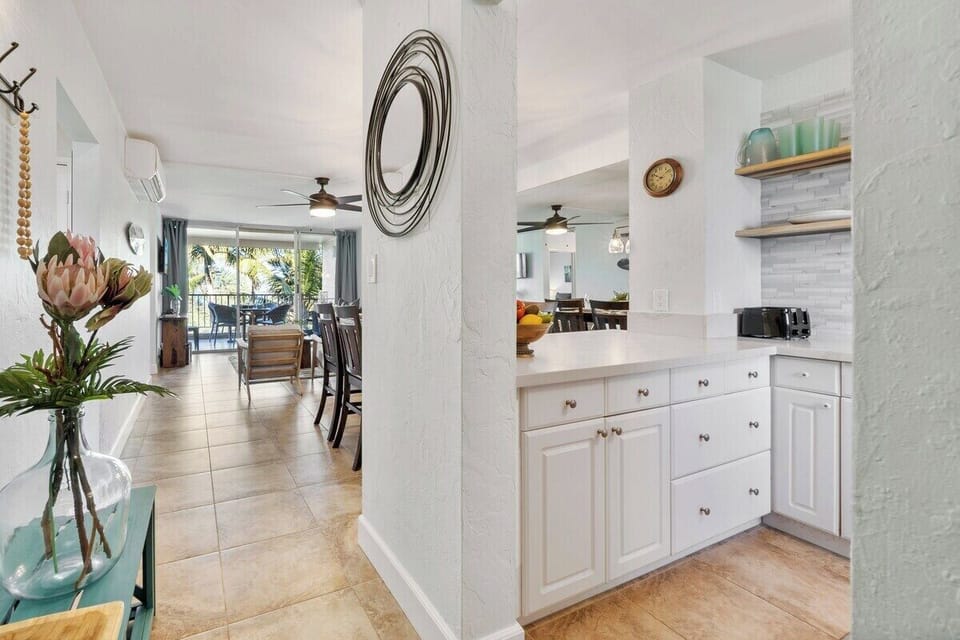 A bright hallway leads into the kitchen, showcasing clean lines and a fresh, airy feel.