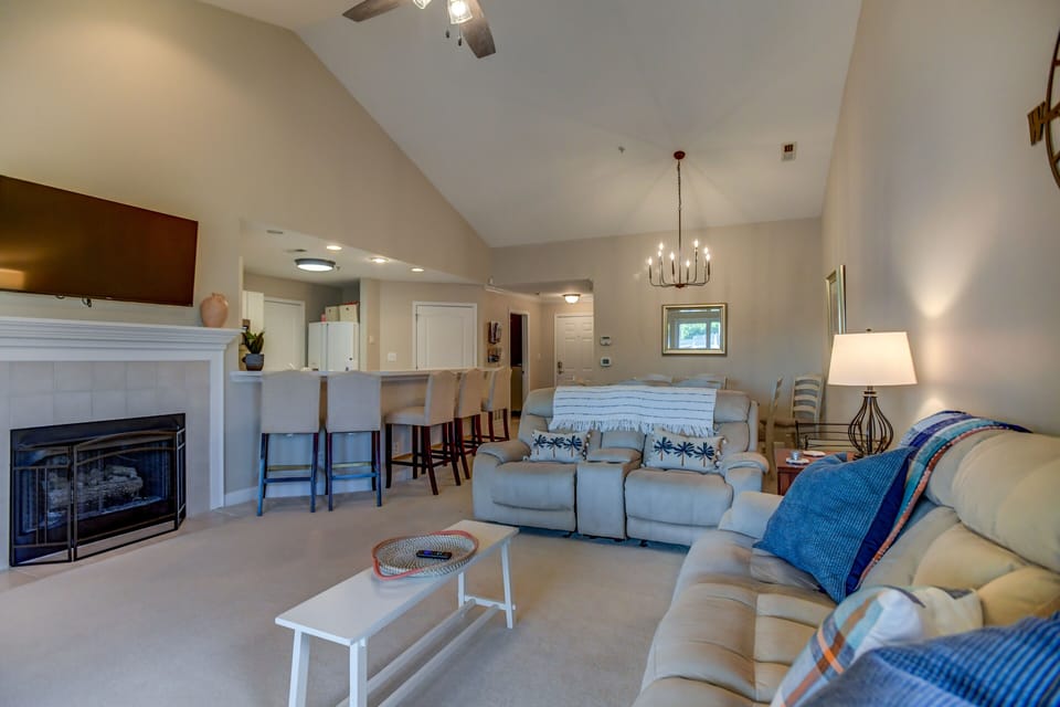 Living room with plenty for seating, TV & deck access.