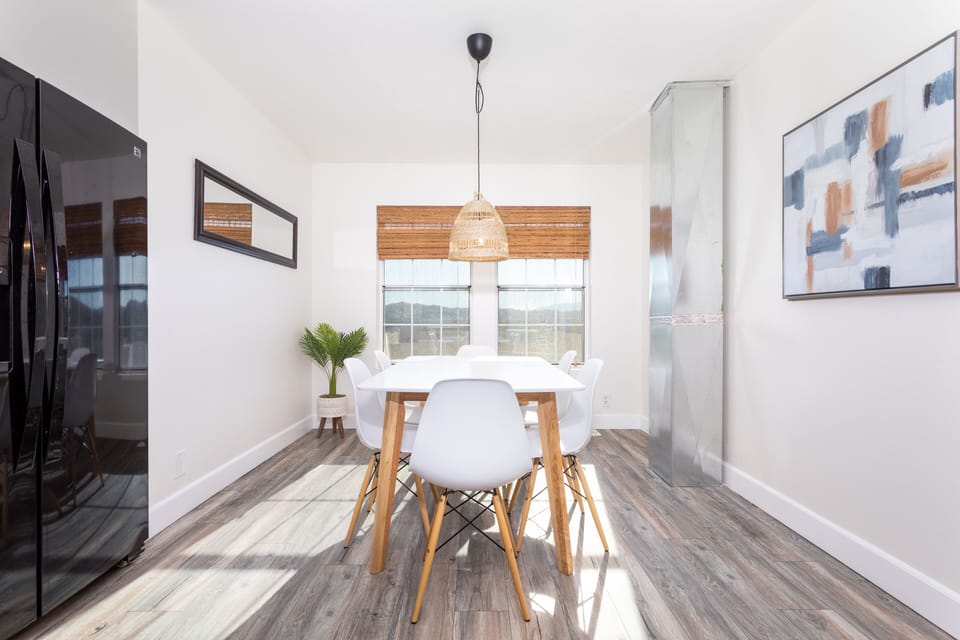 The sunlight filled dining room provides the perfect space for dining or playing