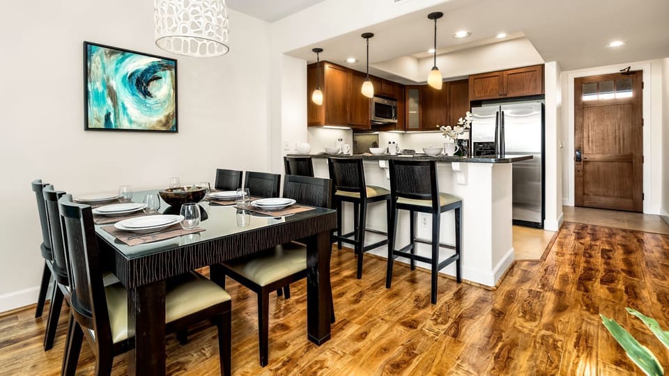 Dining area with unique chandelier, and seating.