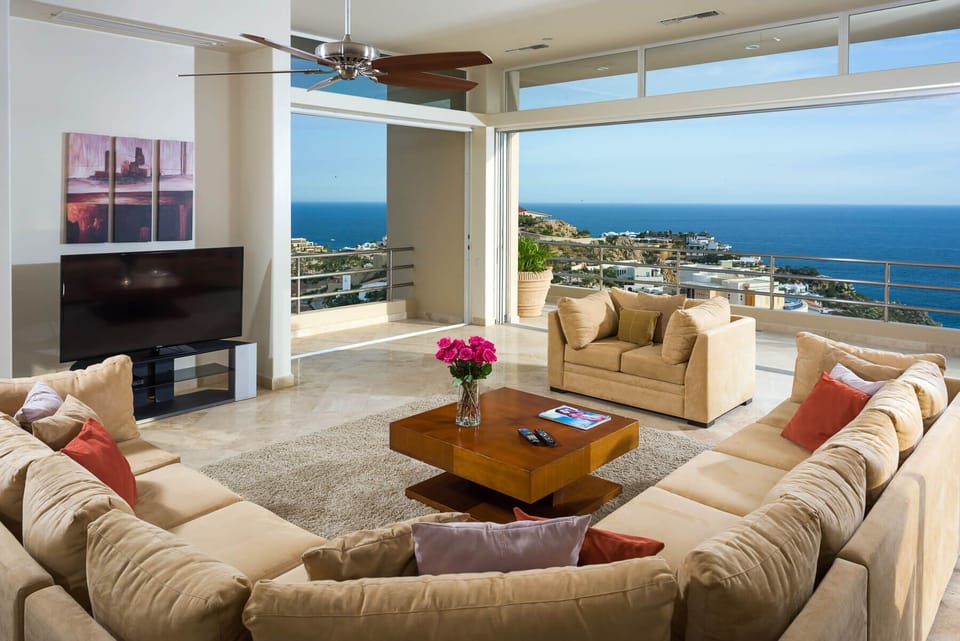 Floor-to-ceiling windows make it easy to move from the terrace into the open concept living and dining area