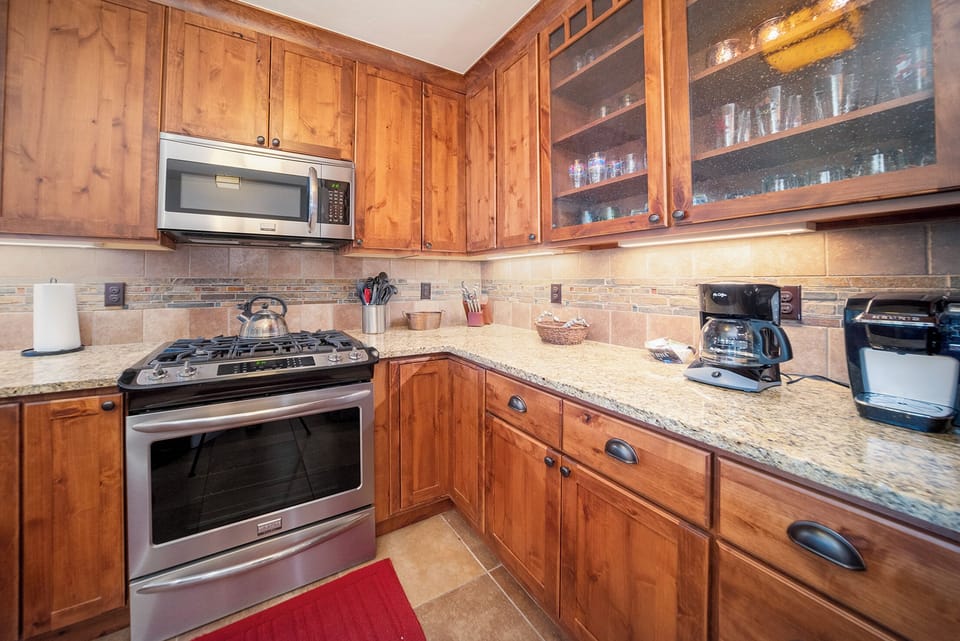 Your fully equipped kitchen features granite counters, stainless appliances, and warm wood cabinets for all your culinary adventures.