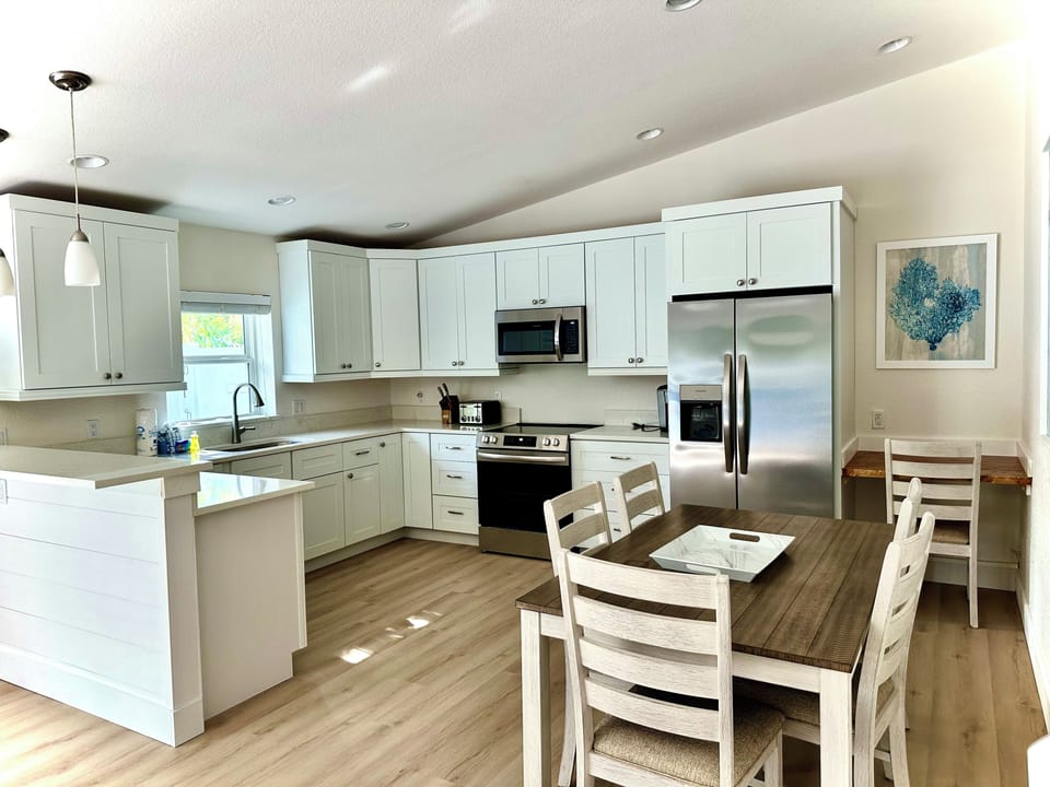 All new kitchen with white quartz counters and stainless steel appliances