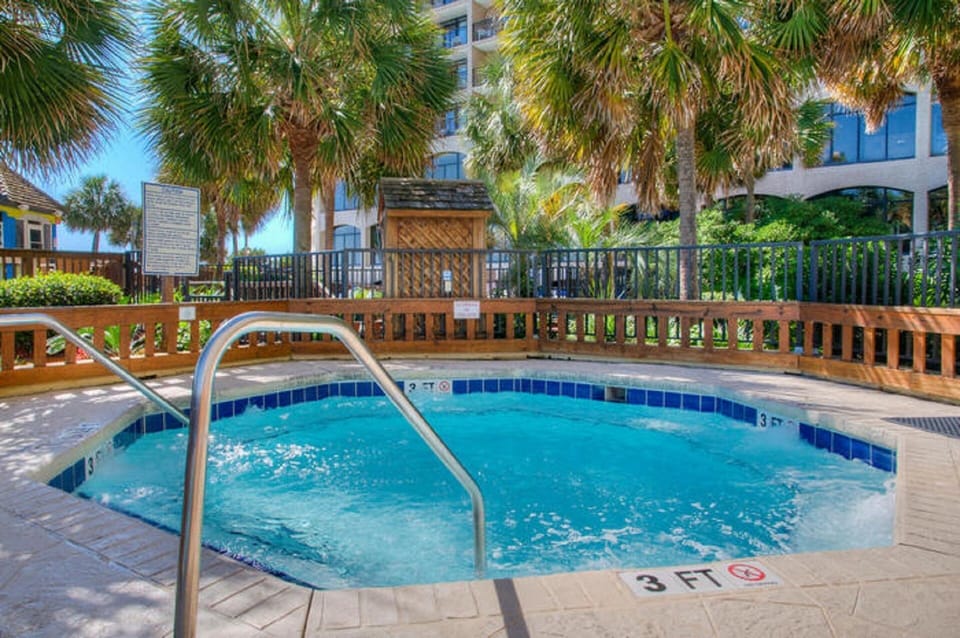 Relax in this hot tub under the palm trees.