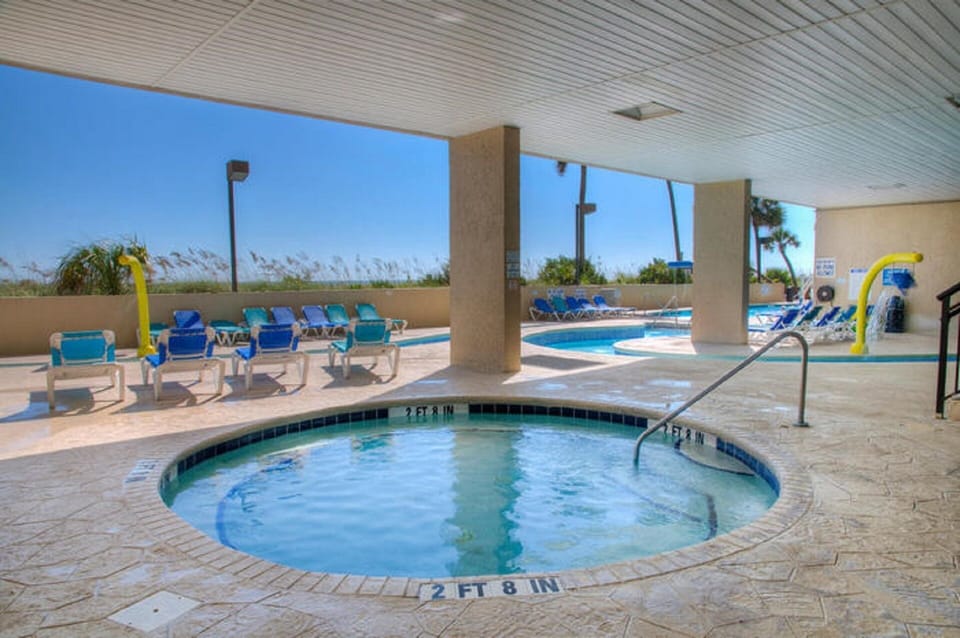 Take a break from the sun and soak in the covered hot tub.