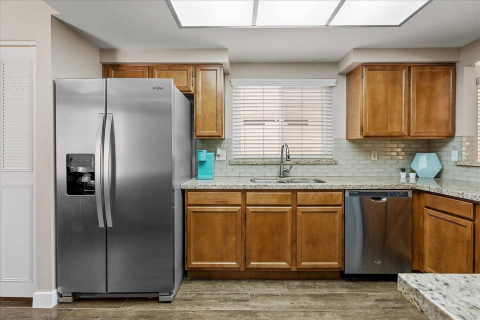 Fully stocked kitchen with granite countertops.