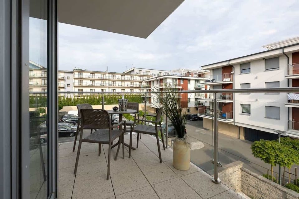 Furnished balcony with green surroundings. 