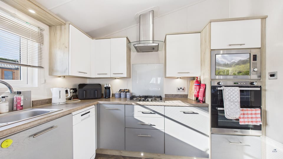 A sleek, fully equipped kitchen with modern appliances, ideal for a self-catering holiday on the island.