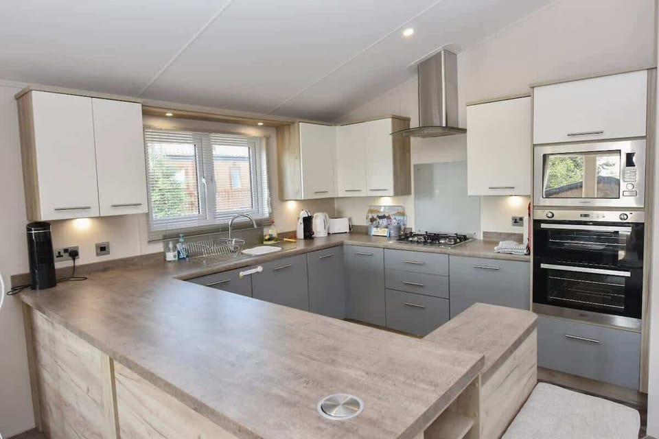 Detail of kitchen appliances at Rowan including oven, microwave and coffee station — perfect for self-catering.
