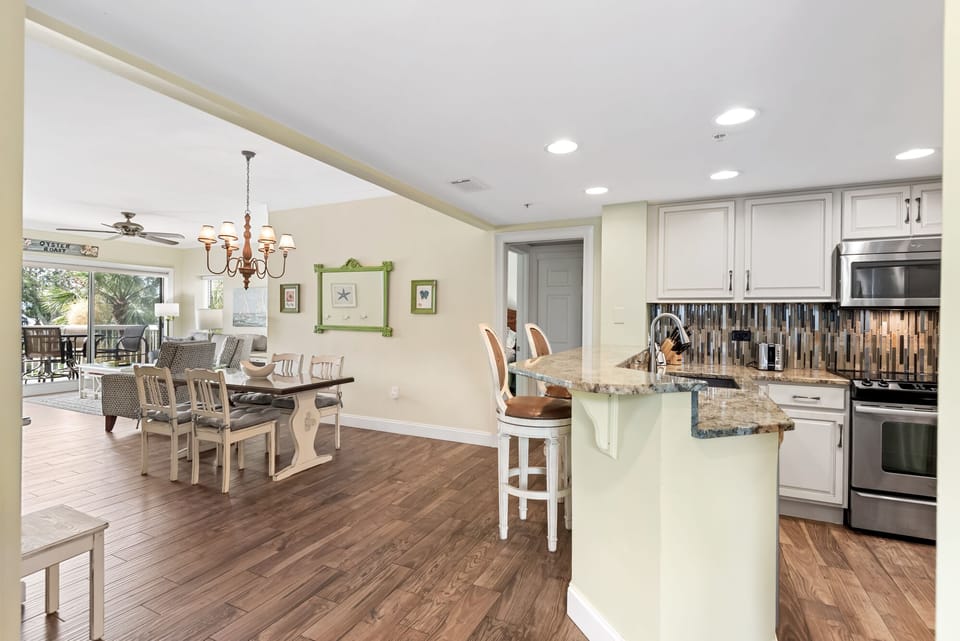 Spacious dining area with table and breakfast bar.
