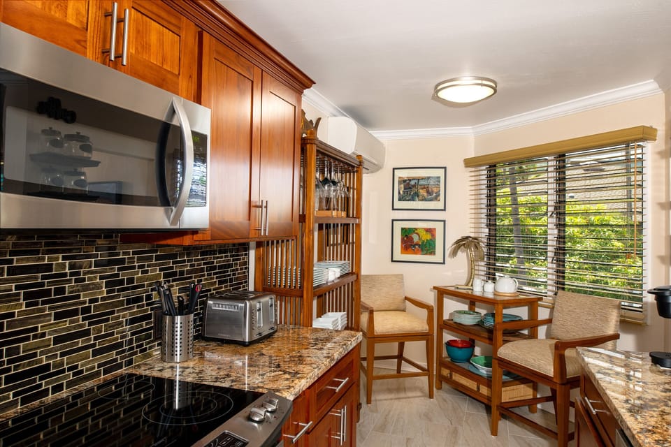 Large, well-appointed kitchen with modern appliances, ample counter space, and a direct view of the ocean as you cook.