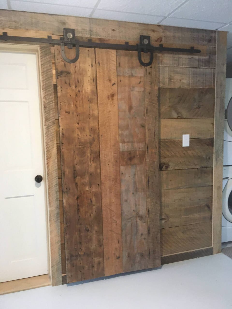 charming vintage barn door near bathroom and laundry