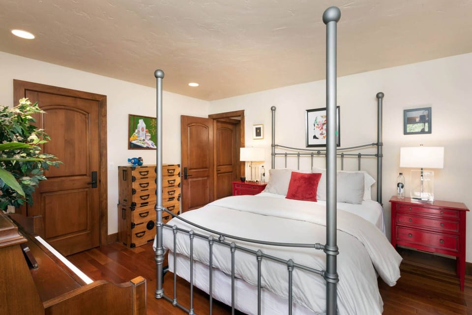 This queen bedroom is located on the lower level and has a piano and private patio area.