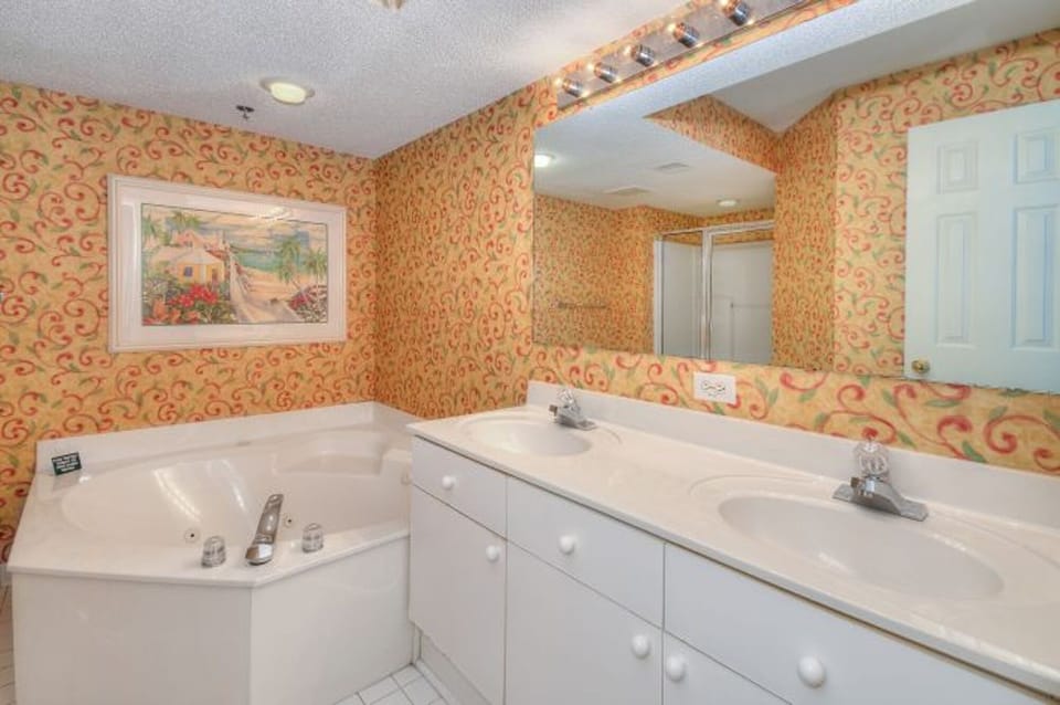 After a fun day on the beach, sink into the soaker tub with a glass of wine.