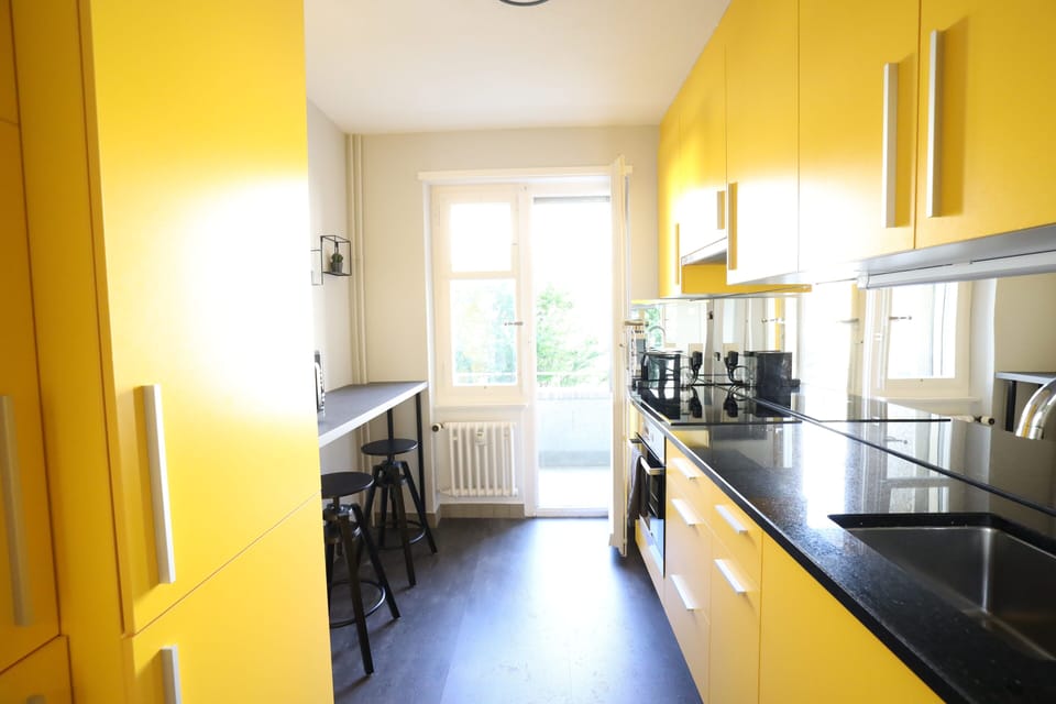 Kitchen has  access to mini balcony facing the street.