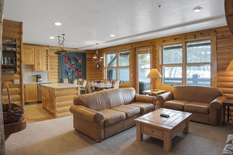 The open concept living room with cozy leather couches.