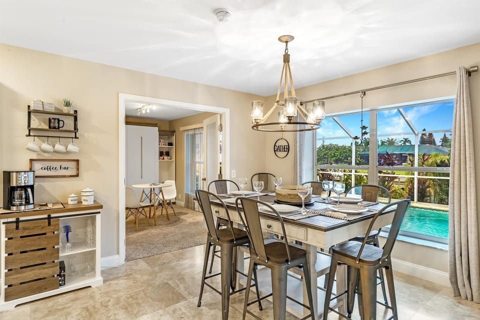 The dining area has a pretty view of the pool and offers seating for six