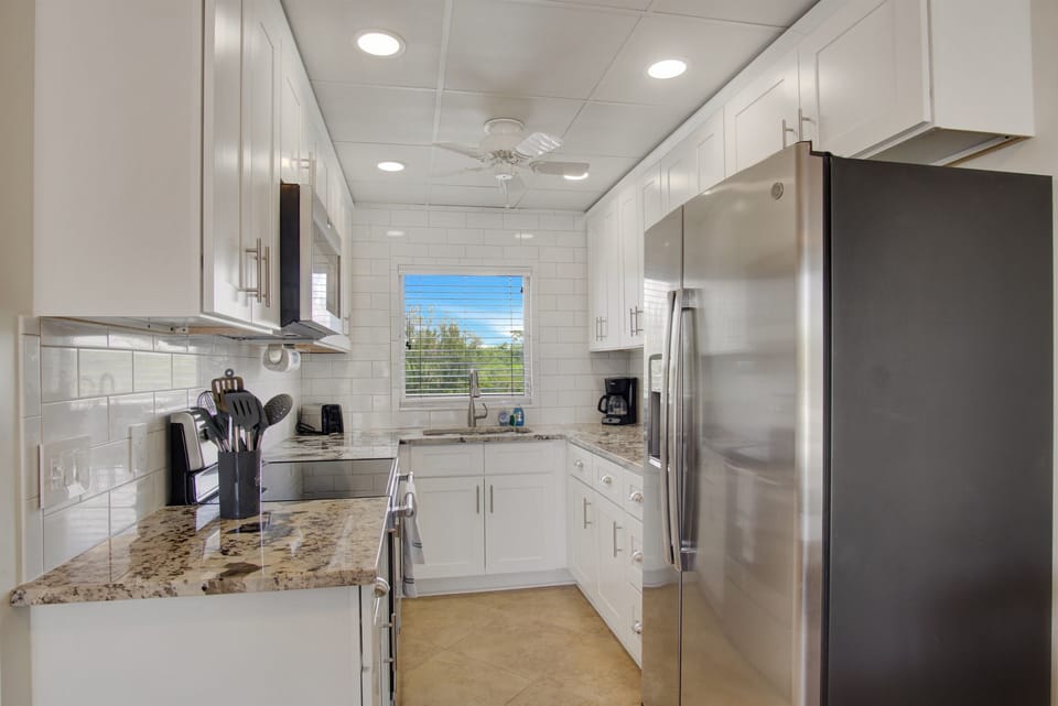 Renovated kitchen, fully stocked with cooking/eating/drinking utensils.