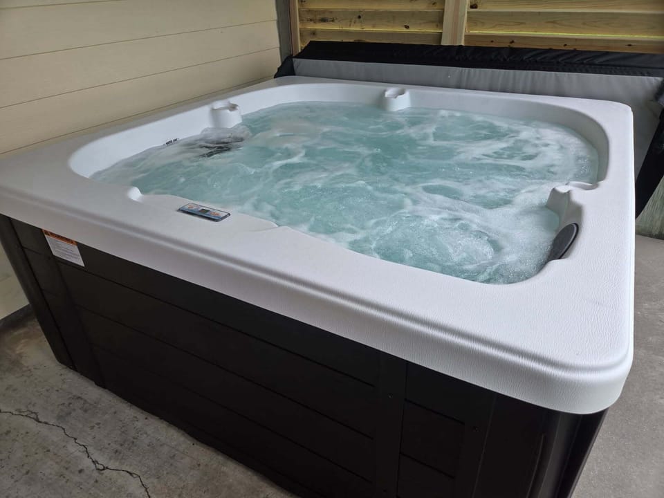 Hot Tub. It will be covered and locked.  You'll have access to the keys. 